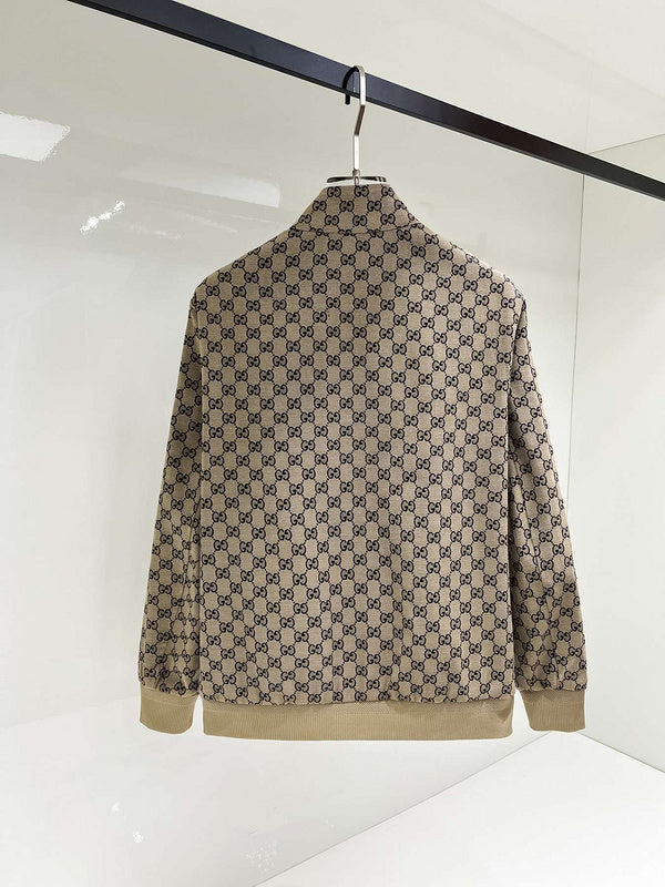 Beige and brown patterned jacket on a hanger against a white background