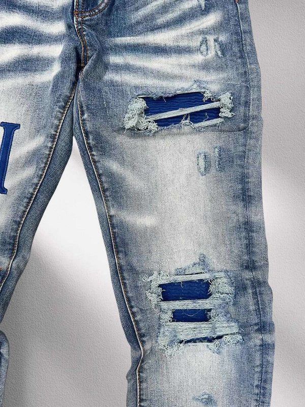 AMIRI Blue Distressed Patchwork Logo Jeans