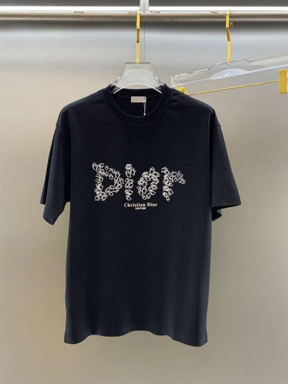 Black t-shirt with white logo on a hanger against a plain background