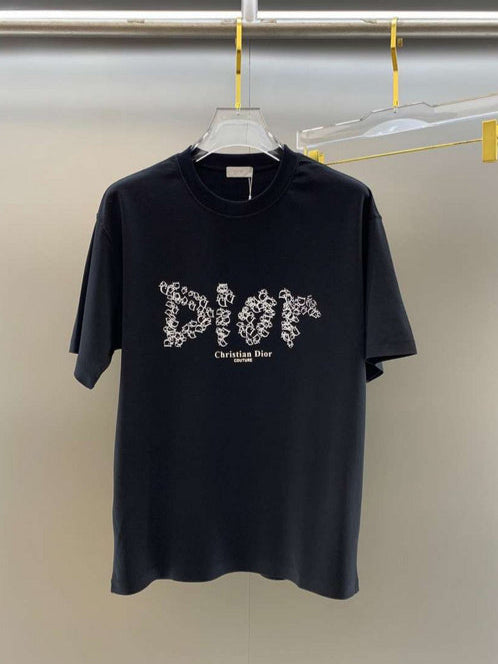 Black t-shirt with white logo on a hanger against a plain background