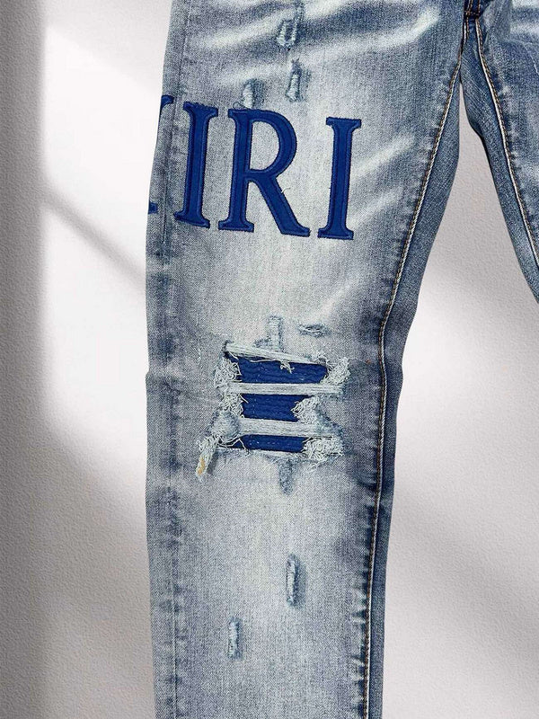 AMIRI Blue Distressed Patchwork Logo Jeans